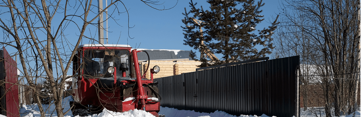 red-diesel-tractor-cleans-road-from-snow-from-left-right-n-country-village-bright-sunny-day-side-view