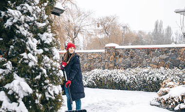 young-woman-cleans-snow-yard-snowy-weather (1)